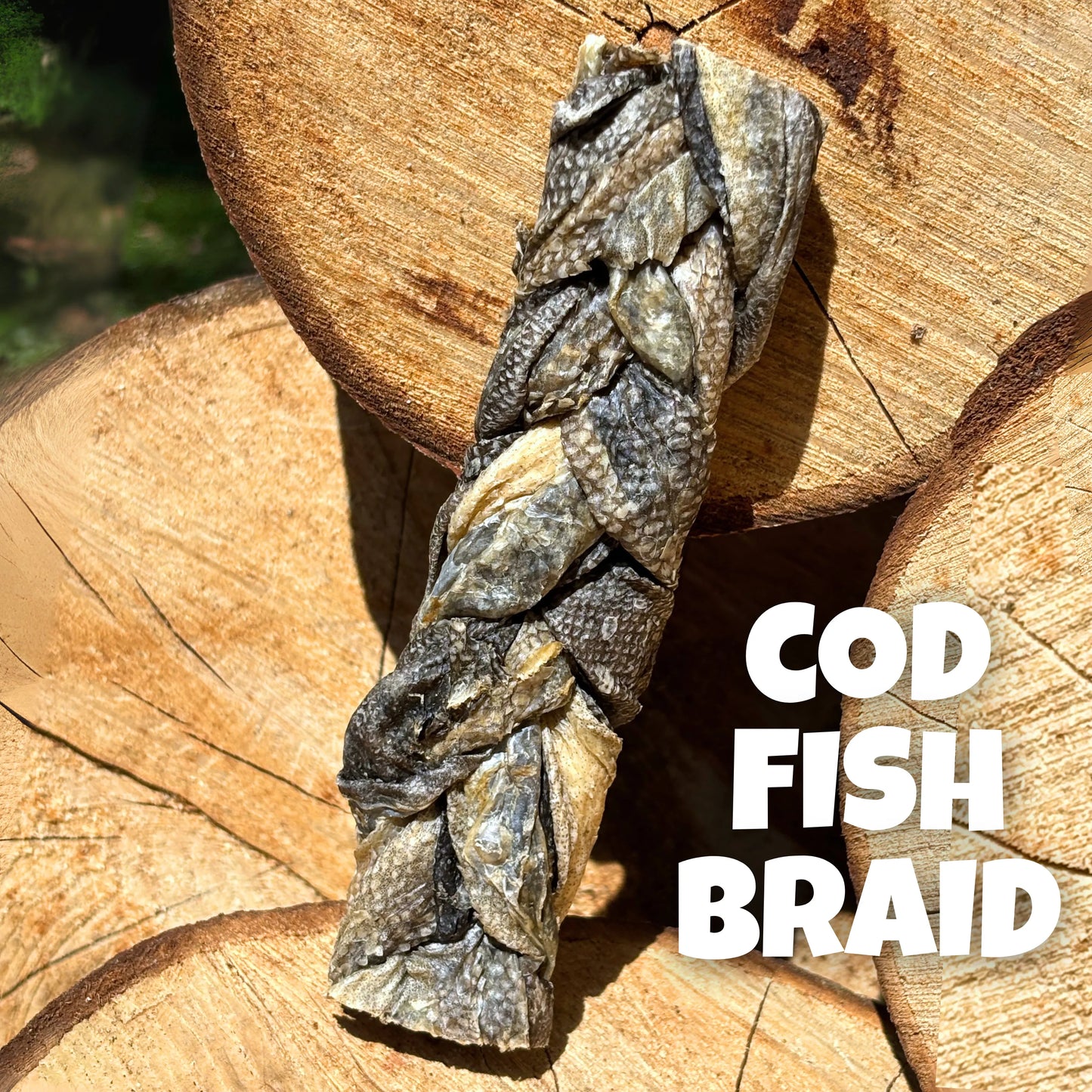 Natural dog treats – premium 100% cod fish braid, air-dried and displayed on rustic wooden logs, perfect for chewing enrichment and skin health.