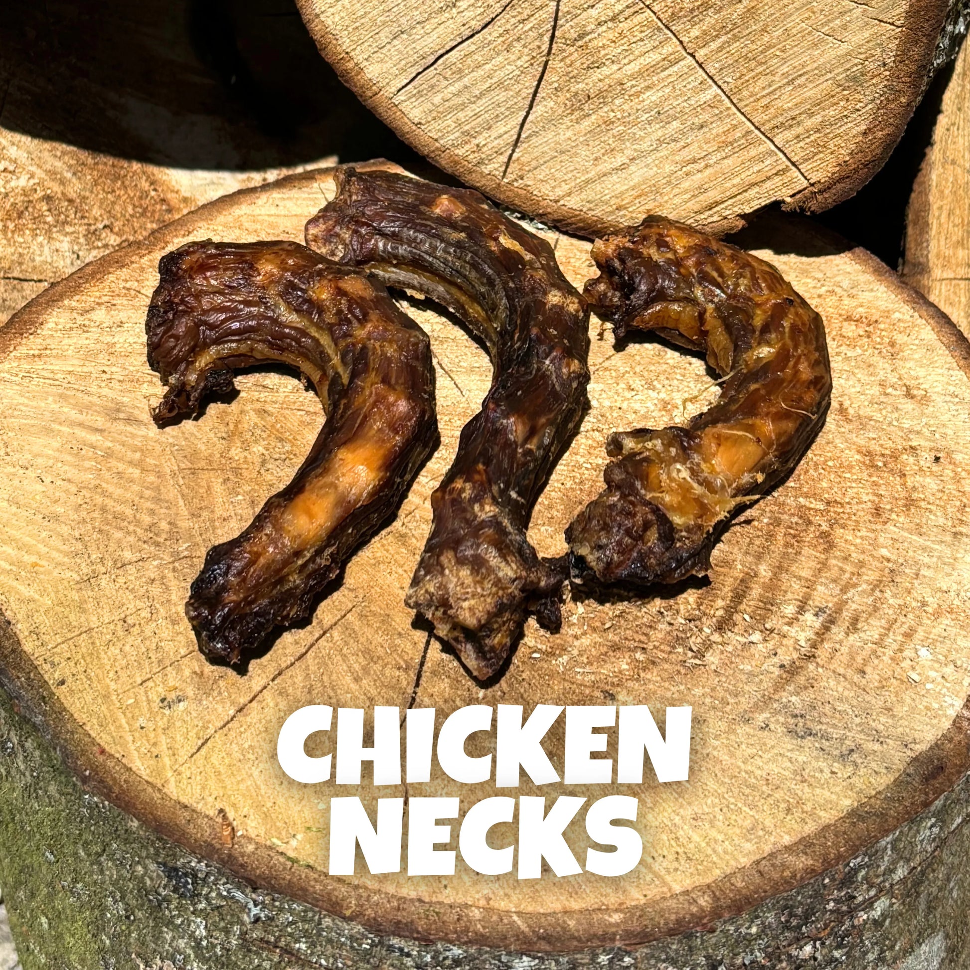 Natural dog treats – crunchy air-dried chicken necks laid on rustic wooden logs, protein-rich chews supporting healthy teeth and joints.