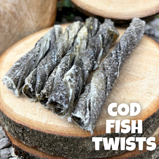Natural dog treats – premium 100% cod fish twists, air-dried and displayed on rustic wooden logs, perfect for chewing enrichment and skin & coat health.
